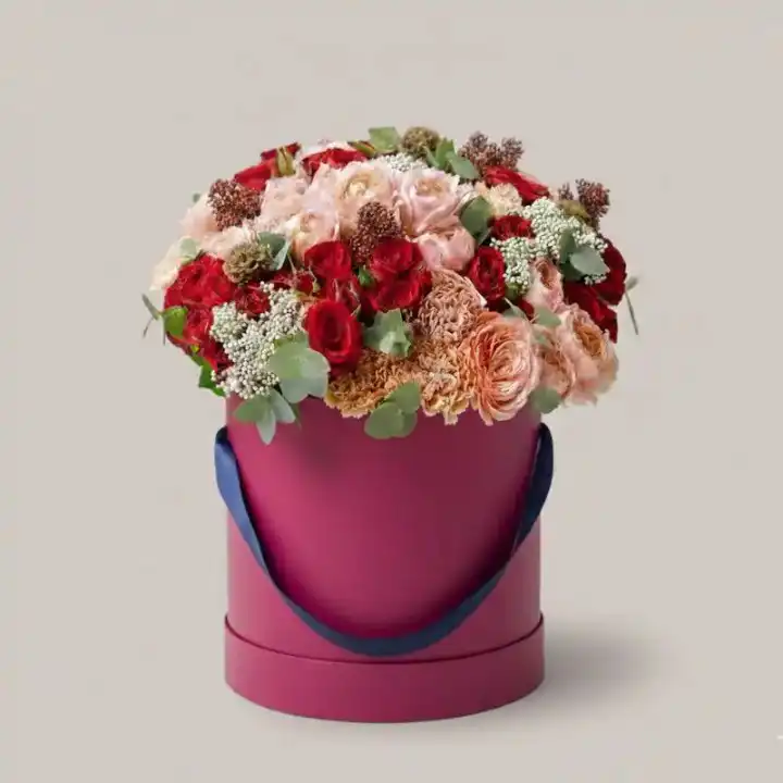 The Grand Romantic Luxury Hatbox 1 A luxurious Red Rose hatbox featuring vibrant crimson blooms tightly arranged in a sophisticated circular container.