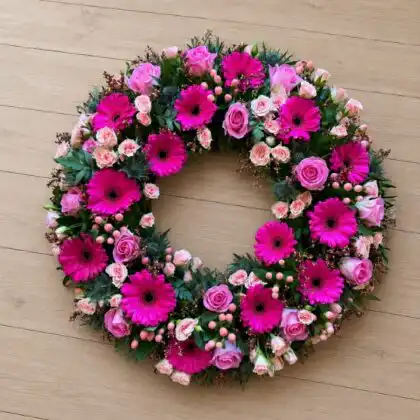 Elegant Pink Rose and Magenta Gerbera Funeral Wreath whit Pink Hypericum Berries , Blue Eryngium (Blue Thistle), Pink Waxflower