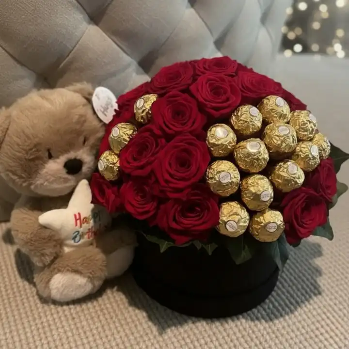 Eternal Red Rose & Ferrero Luxury Hatbox with Plush Keepsake 1 A luxury hatbox featuring vibrant red roses and Ferrero Rocher chocolates, creating a stunning red roses and ferrero bouquet with a plush keepsake.