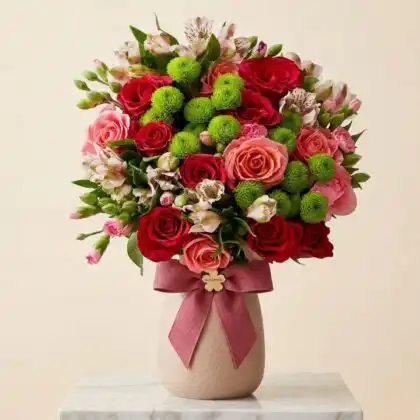 A romantic mini carnation bouquet blended with soft roses wrapped in premium decorative paper for a special occasion.