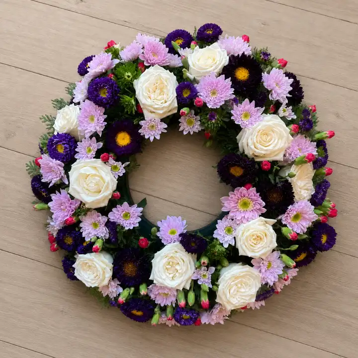 Serene White Rose & Purple Aster Funeral Wreath 1 Serene White Rose & Purple Aster Funeral Wreath with Spray Chrysanthemum , Pink Lisianthus Buds , Red Hypericum Berries