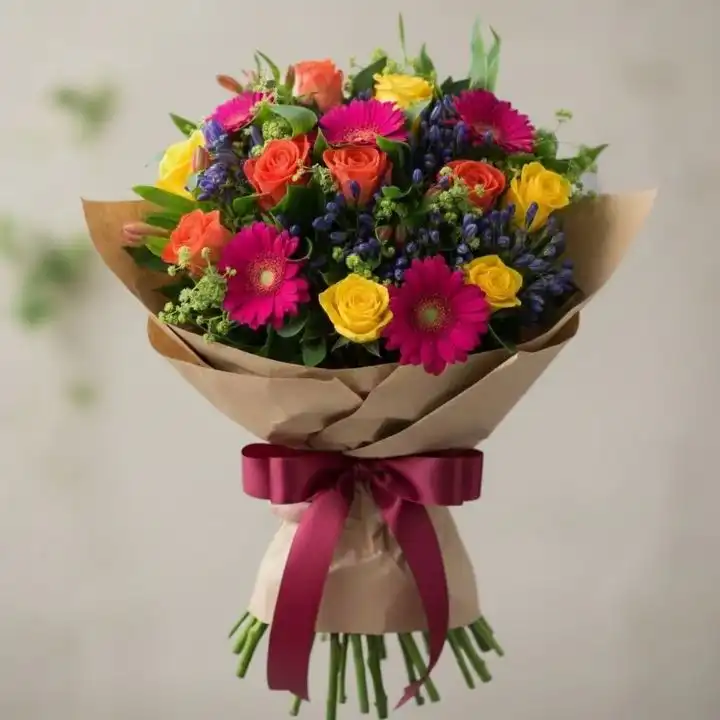 Vibrant Sunshine Rose & Pink Gerbera Hand-Tied Bouquet 1 A hand-tied rose and gerbera daisy bouquet featuring bright yellow roses and soft pink petals in a decorative wrap.