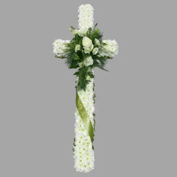 Classic White Sympathy Floral Cross for Funerals 1 An elegant arrangement of white roses and lilies shaped as floral crosses for funerals placed on a wooden easel.