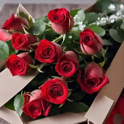 A handcrafted 10 red roses bouquet arranged with fresh greenery inside a luxury cardboard gift box.