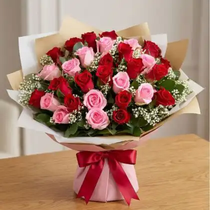 A hand-tied pink and red roses bouquet wrapped in premium paper for a romantic gift.