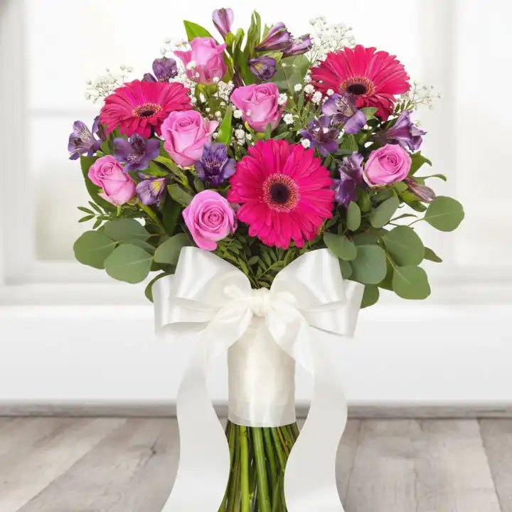 The Pink Lady Bouquet 1 Vibrant Pink Lady bouquet featuring pink gerbera daisies, roses, and purple alstroemeria wrapped in soft pink paper.