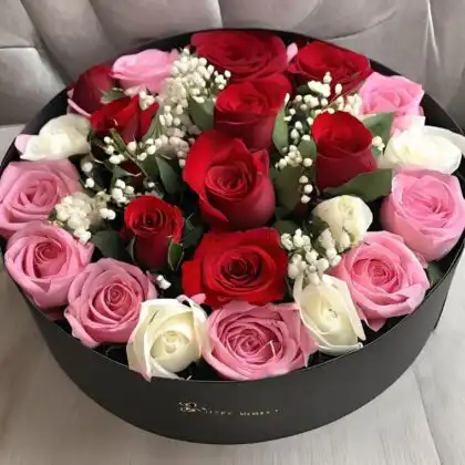 A luxury Rose Flower Box featuring fresh red, pink, and white roses accented with baby's breath in a black box.