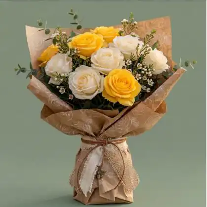 Handcrafted white and yellow flower bouquet featuring fresh roses and eucalyptus wrapped in rustic brown kraft paper.