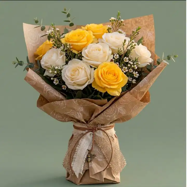Elegant White and Yellow Flower Bouquet 1 Handcrafted white and yellow flower bouquet featuring fresh roses and eucalyptus wrapped in rustic brown kraft paper.