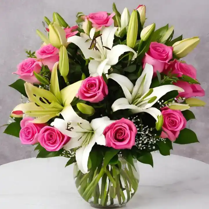 White Lily & Pink Rose Luxury Bouquet 1 A hand-tied white lily and pink rose bouquet with lush green foliage in a sophisticated arrangement.