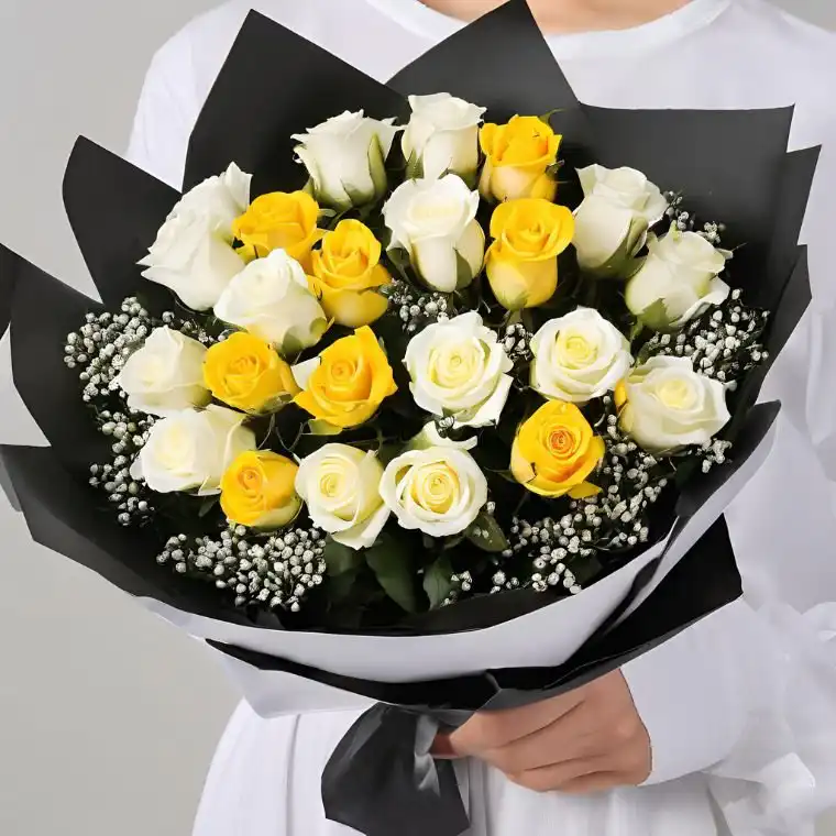 Radiant Yellow & White Roses 1 A beautiful yellow and white rose bouquet arranged with fresh green leaves in a stylish wrap.