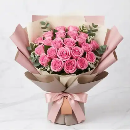 A flower beautiful pink rose bouquet arranged with fresh greenery in a luxury wrap.