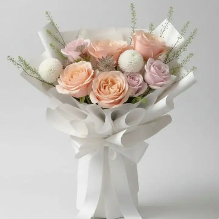 Peach and Pink roses bouquet 1 A fresh peach and pink roses bouquet arranged with white chrysanthemums and greenery in premium white paper wrapping.