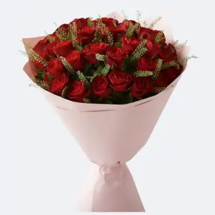 Hand-tied red bouquet roses accented with white lepidium filler in soft pink wrapping.